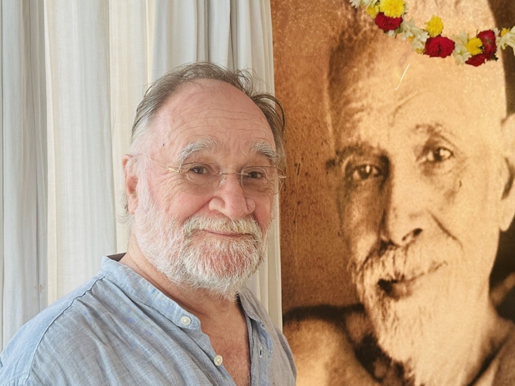 John David in front of a portrait of Sri Ramana Maharshi